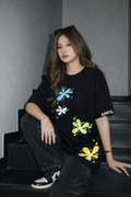Model wearing APR1L Nightshade dark floral aesthetic oversized graphic t-shirt in black.