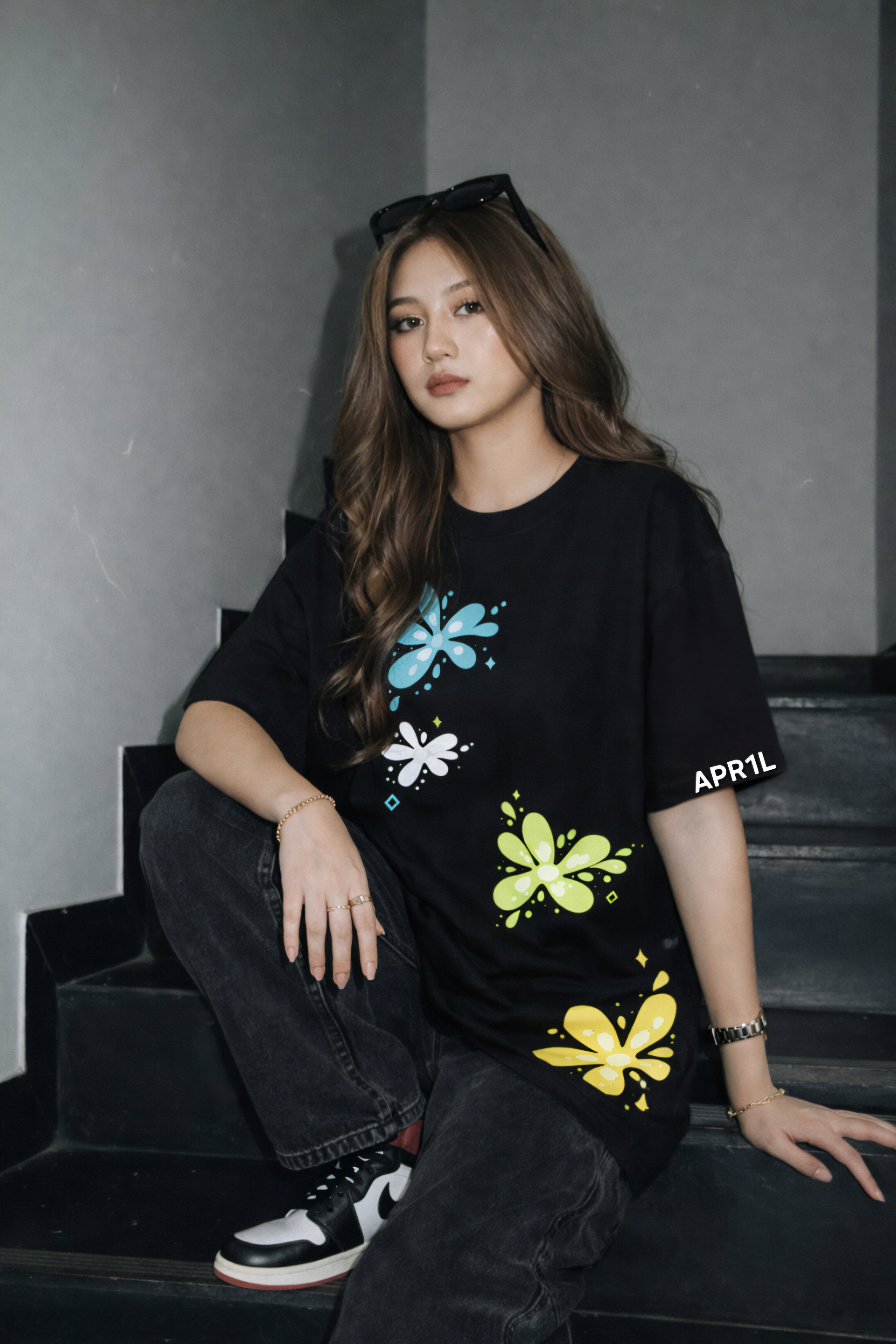 Model wearing APR1L Nightshade dark floral aesthetic oversized graphic t-shirt in black.