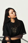 Model wearing APR1L Aura midnight black aesthetic oversized t-shirt with expensive energy only quote.